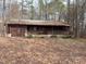 Rustic single-story home featuring a wooden exterior, covered porch, and attached garage at 2408 Homestead Road Rd, Chapel Hill, NC 27516