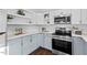 Kitchen with stainless steel appliances and light-colored cabinetry at 2524 Banner St, Durham, NC 27704