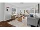 Bright living room with hardwood floors, ample seating, and natural light from large windows at 2524 Banner St, Durham, NC 27704