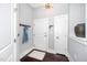 Foyer features a modern light fixture, coat rack, and sleek white doors for a clean and organized entry at 300 Finsbury # 115, Durham, NC 27703