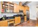 Modern kitchen with stainless steel appliances, wooden cabinets, and black countertop at 300 Finsbury # 115, Durham, NC 27703