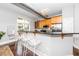 This kitchen includes bar seating, wood cabinets, and stainless steel appliances at 300 Finsbury # 115, Durham, NC 27703