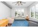 Comfortable living room with a blue patterned rug, large windows, and ample seating space at 300 Finsbury # 115, Durham, NC 27703