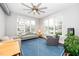 Bright living room featuring large windows, a ceiling fan, and contemporary decor for a cozy atmosphere at 300 Finsbury # 115, Durham, NC 27703