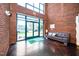 Inviting lobby entrance with exposed brick, modern seating, and a view of the outside through glass doors at 300 Finsbury # 115, Durham, NC 27703