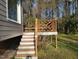View of the backyard featuring a wooden deck with stairs and green lawn at 3616 Open Sight Ct, Raleigh, NC 27616