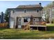 Exterior view of home and backyard featuring a wooden deck, gray siding, and manicured lawn at 3616 Open Sight Ct, Raleigh, NC 27616