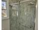 Beautiful bathroom features a glass shower enclosure with handrails and tiled walls at 3616 Open Sight Ct, Raleigh, NC 27616