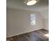 Bedroom featuring hardwood floors, a window, and a ceiling light at 3616 Open Sight Ct, Raleigh, NC 27616