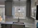 This kitchen features gray cabinetry, stainless steel appliances, granite countertops, and natural lighting at 3616 Open Sight Ct, Raleigh, NC 27616
