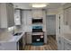 New kitchen with gray cabinets, stainless appliances and granite countertops at 3616 Open Sight Ct, Raleigh, NC 27616
