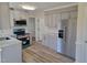 New kitchen with gray cabinets, stainless appliances, and granite countertops at 3616 Open Sight Ct, Raleigh, NC 27616