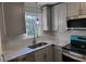 Kitchen featuring modern stainless steel appliances, gray cabinets, and marble-style countertops at 3616 Open Sight Ct, Raleigh, NC 27616