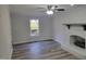 Living room with new floors, a fireplace, and a window with a yard view at 3616 Open Sight Ct, Raleigh, NC 27616