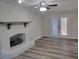 Spacious living room with a fireplace, ceiling fan, and doors to the outside deck at 3616 Open Sight Ct, Raleigh, NC 27616