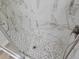 Sleek shower with elegant marble-patterned tile and a mosaic tiled floor at 3616 Open Sight Ct, Raleigh, NC 27616