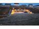 Outdoor backyard stone patio features a cozy fire pit and stylish bar seating, perfect for evening entertaining at 400 Access Dr, Youngsville, NC 27596