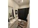 Well-lit bathroom featuring granite countertop, decorative mirror, and shower with dark curtain at 400 Access Dr, Youngsville, NC 27596