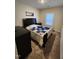 Cozy bedroom with carpeted floor, one window, dark bed, and black dresser at 400 Access Dr, Youngsville, NC 27596