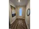 Bright entryway with wood-look flooring, white trim, and an eye catching art piece on the wall at 400 Access Dr, Youngsville, NC 27596
