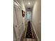 Hallway with long decorative rug and multiple white panel doors leading to bedrooms at 400 Access Dr, Youngsville, NC 27596