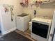 Functional laundry room with washer, dryer, shelving, and modern flooring at 400 Access Dr, Youngsville, NC 27596