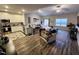Open-concept living space with modern décor and wood-look flooring flowing into the dining area and kitchen at 400 Access Dr, Youngsville, NC 27596