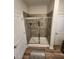 Bathroom shower featuring glass doors and tile surround, showcasing the home's modern updates at 400 Access Dr, Youngsville, NC 27596