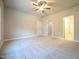 Large bedroom features carpeted floors, neutral walls, a ceiling fan, and 2 closets at 400 S Eastwood Dr, Benson, NC 27504