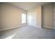 Bright bedroom with plush carpet, neutral walls, a closet, and a window at 400 S Eastwood Dr, Benson, NC 27504