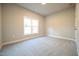 Bright bedroom features neutral paint, plush carpet and a large window allowing for an abundance of natural light at 400 S Eastwood Dr, Benson, NC 27504