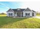 Charming single-story home featuring gray and white siding, black shutters, and a well-manicured lawn at 400 S Eastwood Dr, Benson, NC 27504