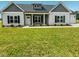 Charming single-story home with a well-manicured lawn, symmetrical design, and welcoming entrance at 400 S Eastwood Dr, Benson, NC 27504