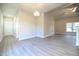 Bright living room featuring luxury vinyl plank flooring, a modern ceiling fan, and lots of natural light at 400 S Eastwood Dr, Benson, NC 27504