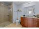 Modern bathroom includes a tiled walk-in shower and granite countertops at 400 W North St # 900, Raleigh, NC 27603