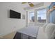 Cozy bedroom has large windows with city views and a wall-mounted television at 400 W North St # 900, Raleigh, NC 27603