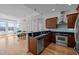 Open kitchen and living area with stainless appliances, breakfast bar, and ample counter space at 400 W North St # 900, Raleigh, NC 27603