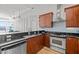 Well-appointed kitchen with stainless steel appliances, granite counters, and open layout to living space at 400 W North St # 900, Raleigh, NC 27603