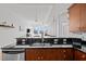 Modern kitchen with stainless steel appliances, dark countertops, and an open view to the living area at 400 W North St # 900, Raleigh, NC 27603