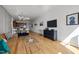 Wide angle view of the living room and kitchen with hardwood floors and large TV at 400 W North St # 900, Raleigh, NC 27603