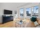 Cozy living room with hardwood floors, modern furniture, and abundant natural light at 400 W North St # 900, Raleigh, NC 27603