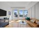 Bright living room featuring hardwood floors, neutral walls and city views through large windows at 400 W North St # 900, Raleigh, NC 27603