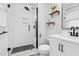 Modern bathroom featuring a tiled shower, floating shelves, and matte black finishes at 409 Dartmouth Rd, Raleigh, NC 27609