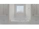 Bright bathroom featuring a soaking tub with tile surround and window at 42 Galaxy Dr, Garner, NC 27529
