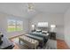 Bright bedroom features wood floors, a ceiling fan, and a large window at 42 Galaxy Dr, Garner, NC 27529