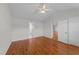Well-lit bedroom with hardwood floors, featuring doorways to the bathroom and other rooms at 42 Galaxy Dr, Garner, NC 27529