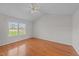 Bright bedroom with wood floors, a ceiling fan, and large windows offering ample natural light at 42 Galaxy Dr, Garner, NC 27529