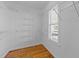 Walk-in closet with wire shelving, a window, and hardwood floors at 42 Galaxy Dr, Garner, NC 27529