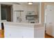 Bright kitchen featuring white appliances, plenty of cabinets and a breakfast bar with white countertop at 42 Galaxy Dr, Garner, NC 27529