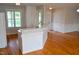 Bright kitchen with hardwood floors featuring white countertop breakfast bar, and stainless sink at 42 Galaxy Dr, Garner, NC 27529